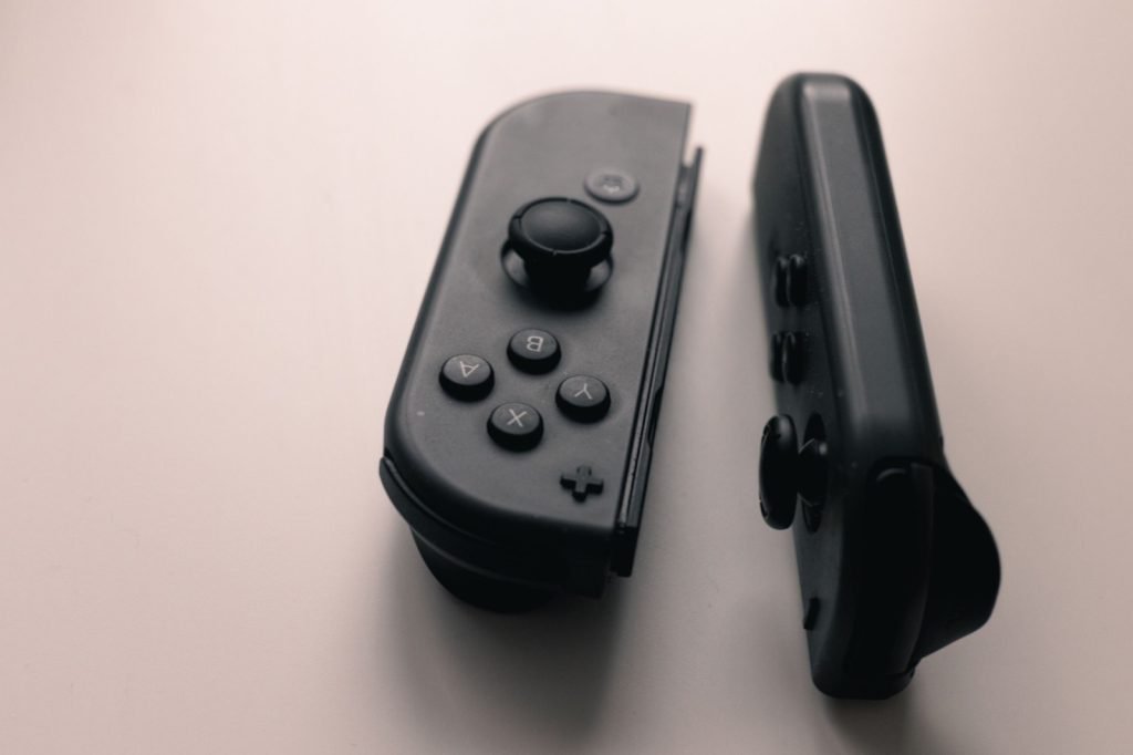 A pair of black Nintendo Switch Joy-Con controllers on a neutral background