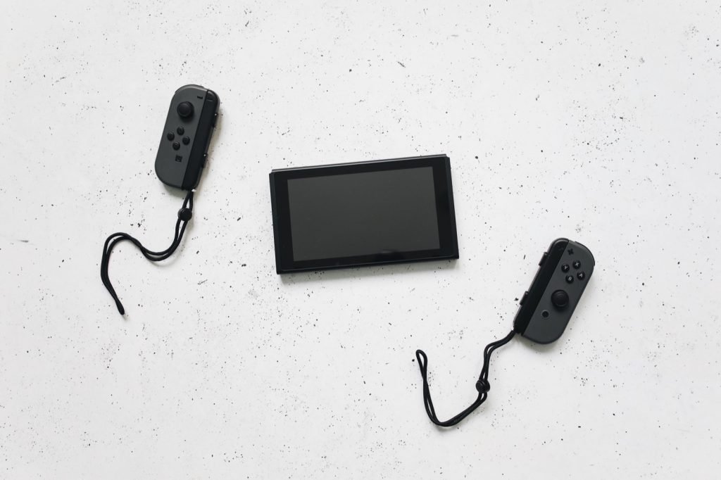 A Nintendo Switch console laid out with both Joy-Con controllers detached