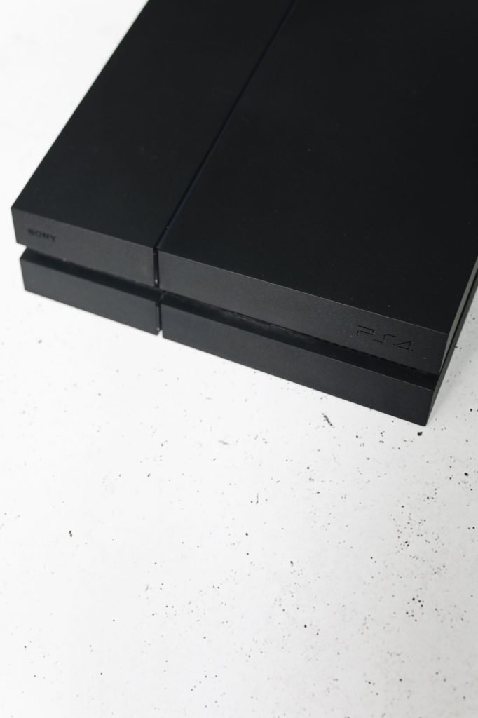 A black PlayStation 4 console on a plain white surface