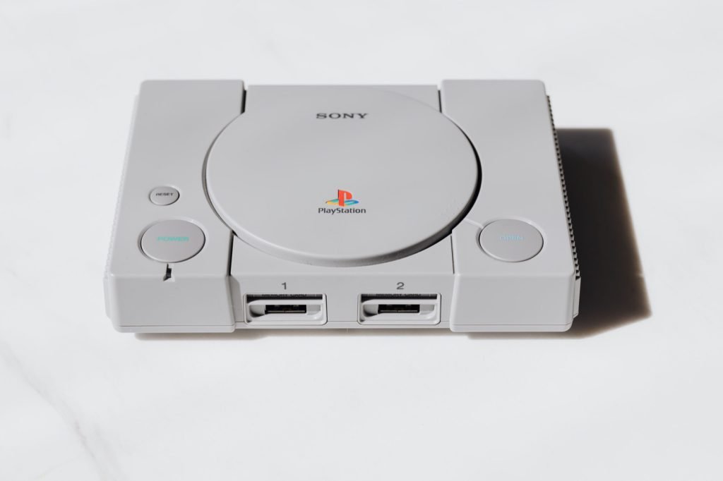 An original grey Sony PlayStation console on a white background