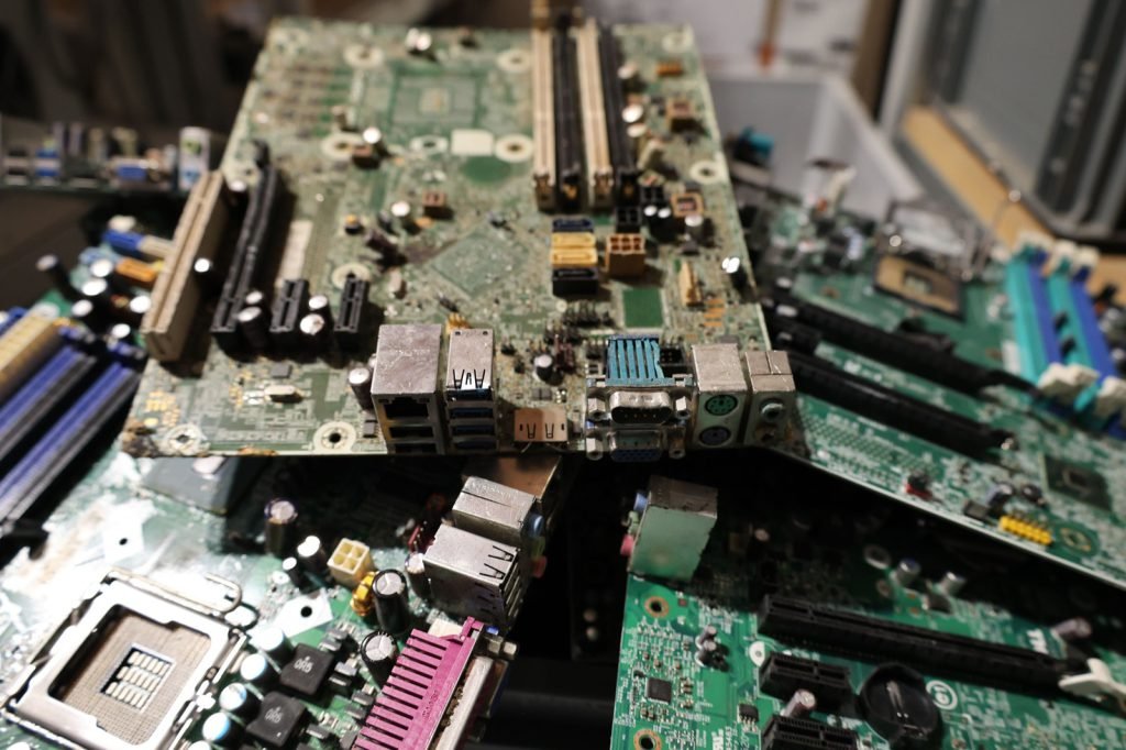 A pile of stripped motherboards and circuit boards awaiting processing