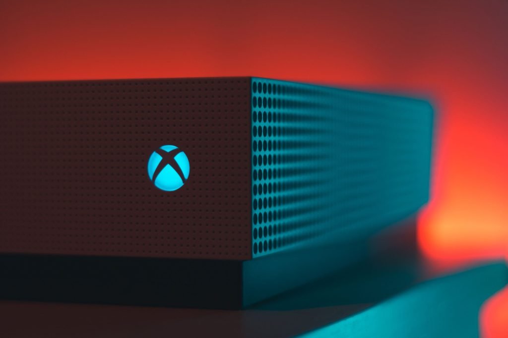 An Xbox console lit by a red glow, suggesting a fault state