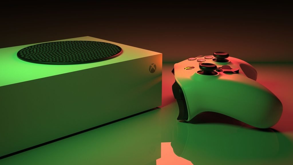 An Xbox Series S console beside its wireless controller under coloured lighting